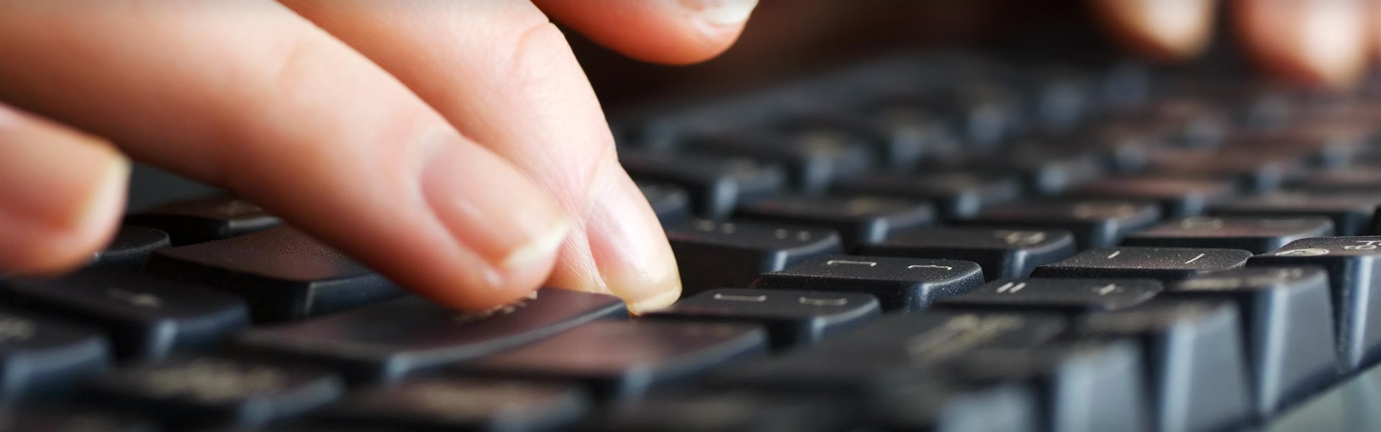 Person Typing on Keyboard